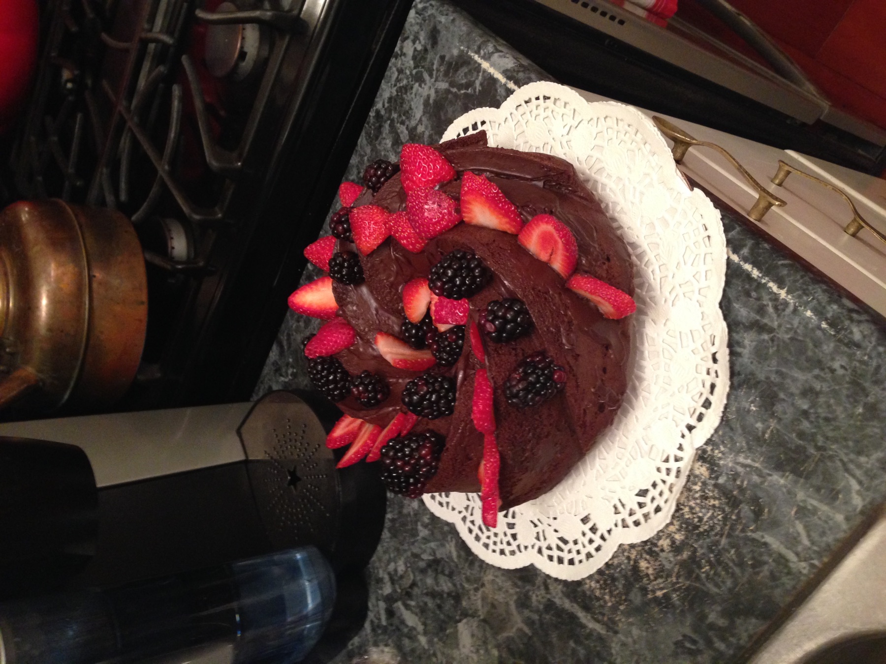 Chocolate cake topped with strawberries and blackberries