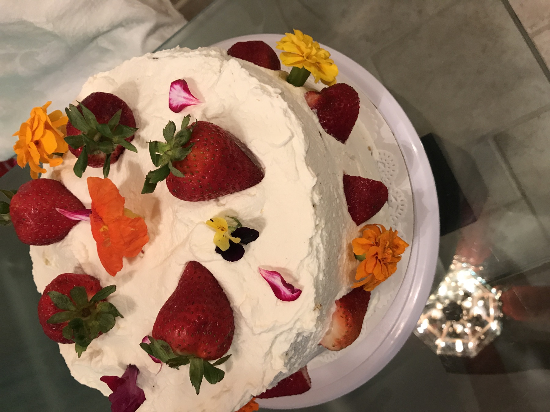 A strawberry cake decorated with colorful flowers